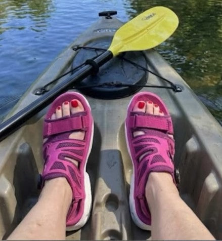 woman on kayak showing feet only wearing amento martlett sandals in merlot colorway.  yellow paddle in background. 