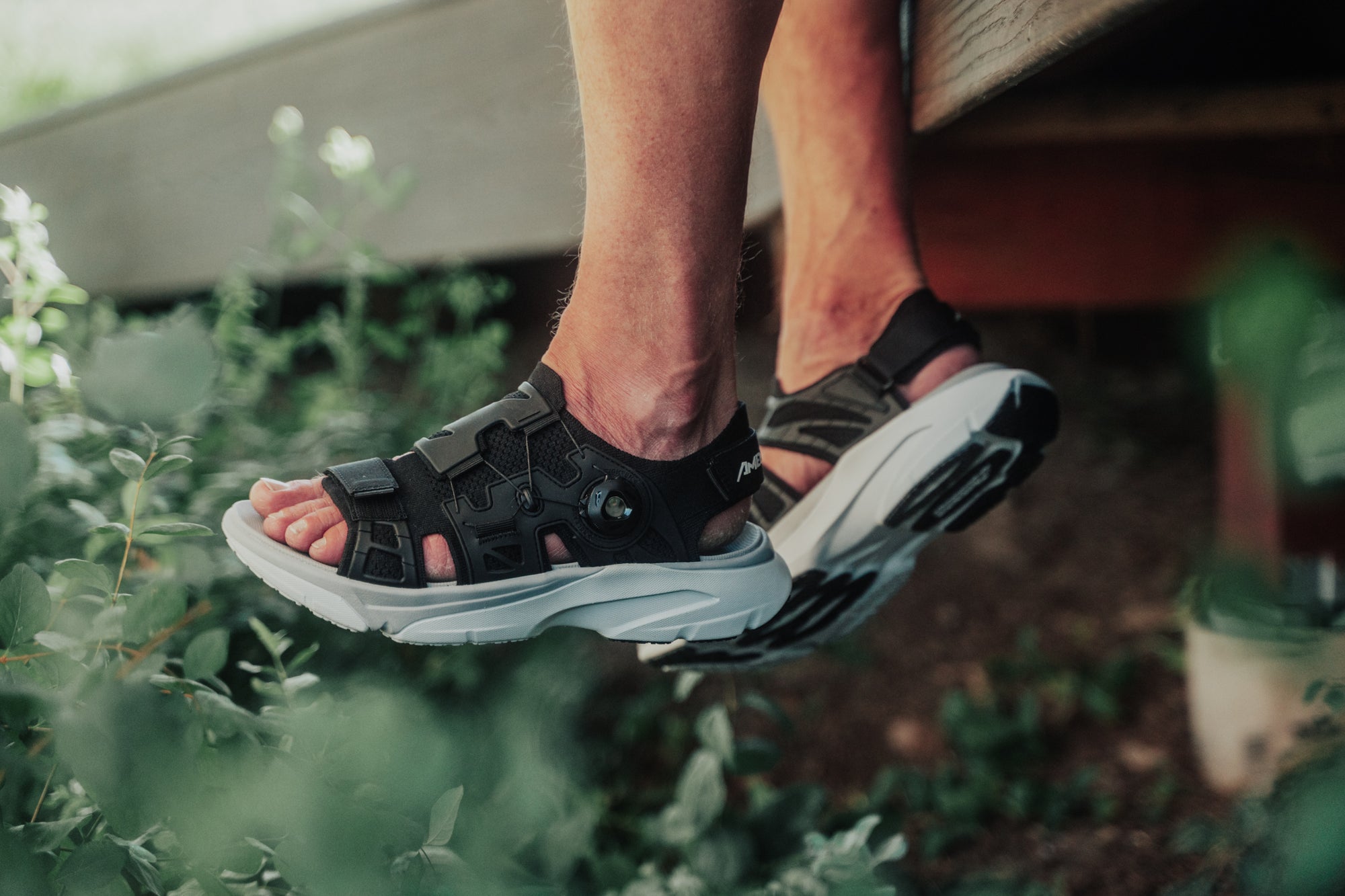 image of man's feet dangling off patio porch wearing men's amento martlett in black colorway
