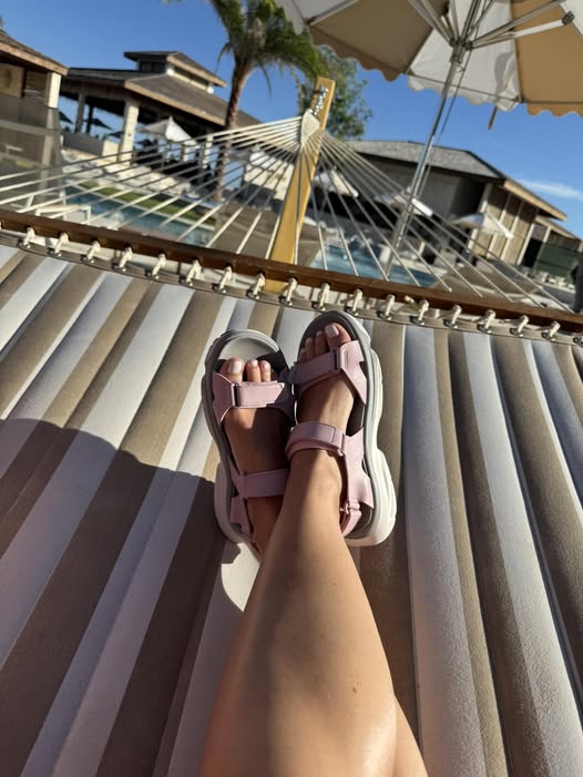 image of legs of woman relaxing in a hammock in tropical resort wearing amento women's hovera in mauve